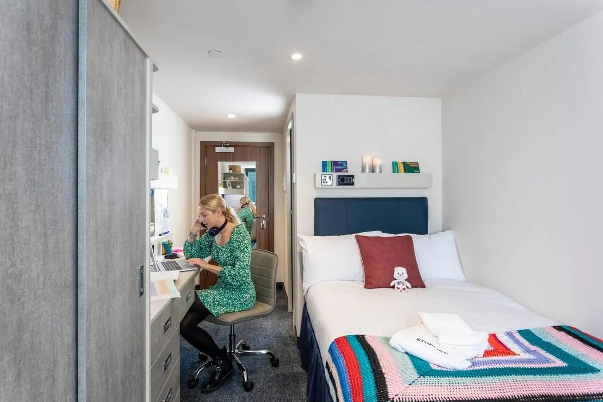 Desk wardrobe bed with colorful blanket Bedroom at Reynard House in Leicester Student Accommodation
