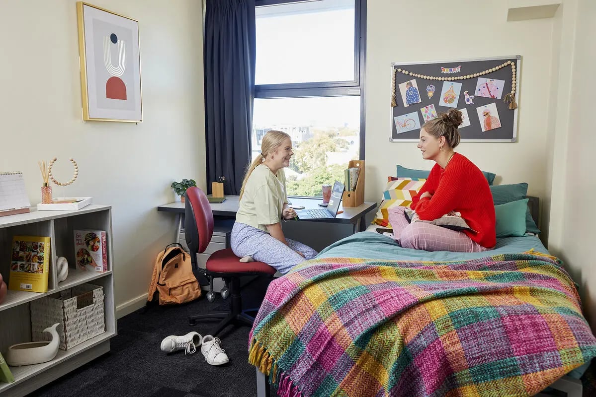 Two students at desk and bed bedroom at Broadway x Scape in Sydney Student Accommodation