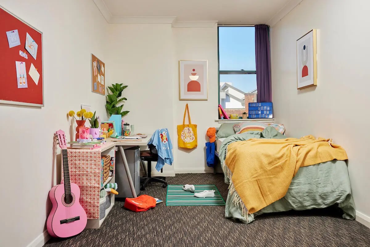 Pink guitar desk and bed bedroom at Mountain x Scape in Sydney Student Accommodation
