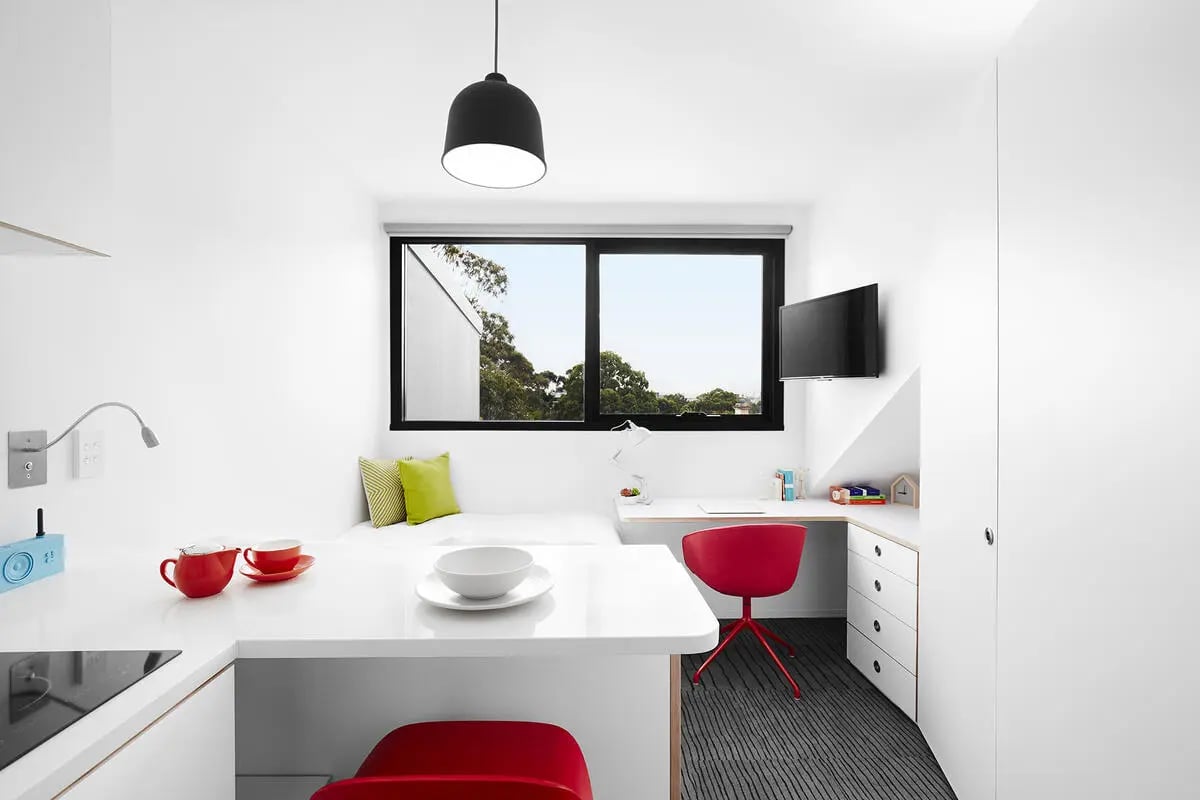 Bed desk window red chair student room at Scape Abercrombie in Sydney Student Accommodation
