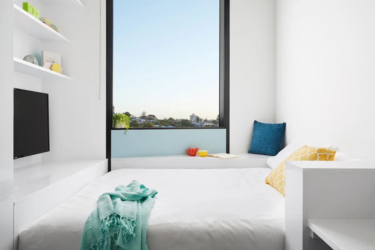 Bed white blanket pillows and window view bedroom at Scape South Bank in Brisbane Student Accommodation
