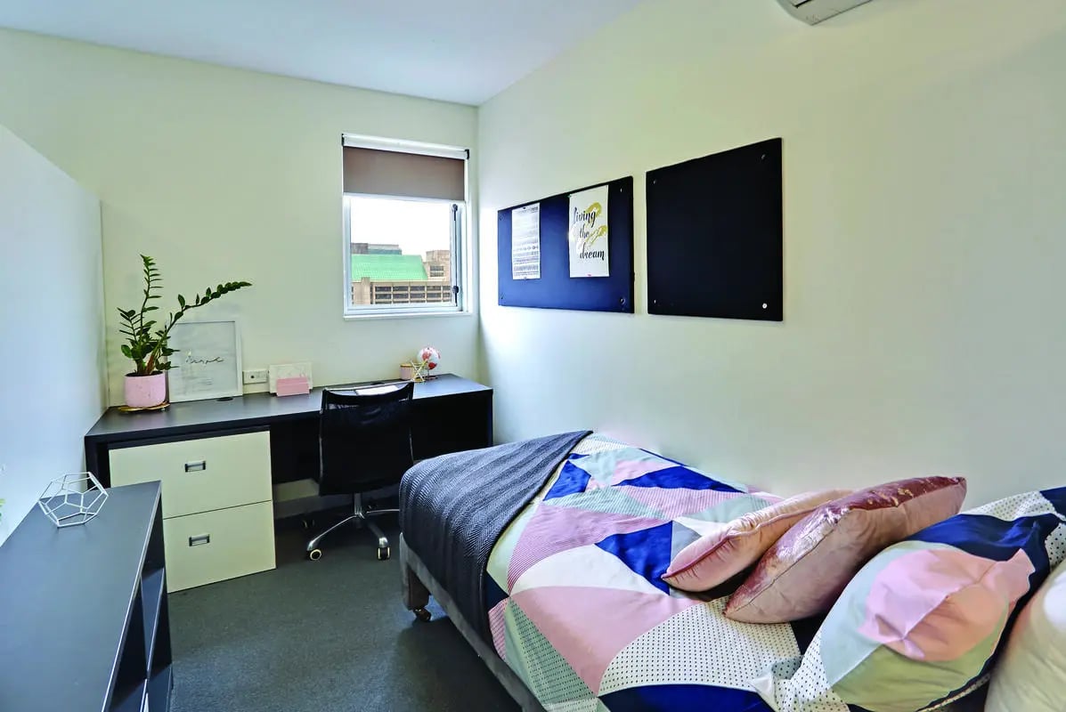 Bed desk plant window whiteboard bedroom at Scape Adelaide Central in Adelaide Student Accommodation