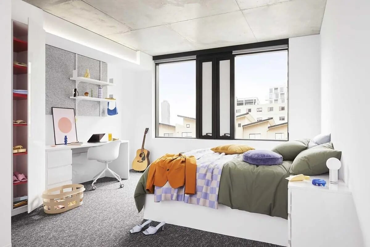 Bed desk guitar storage shelves bedroom at Scape Lincoln College in Melbourne Student Accommodation