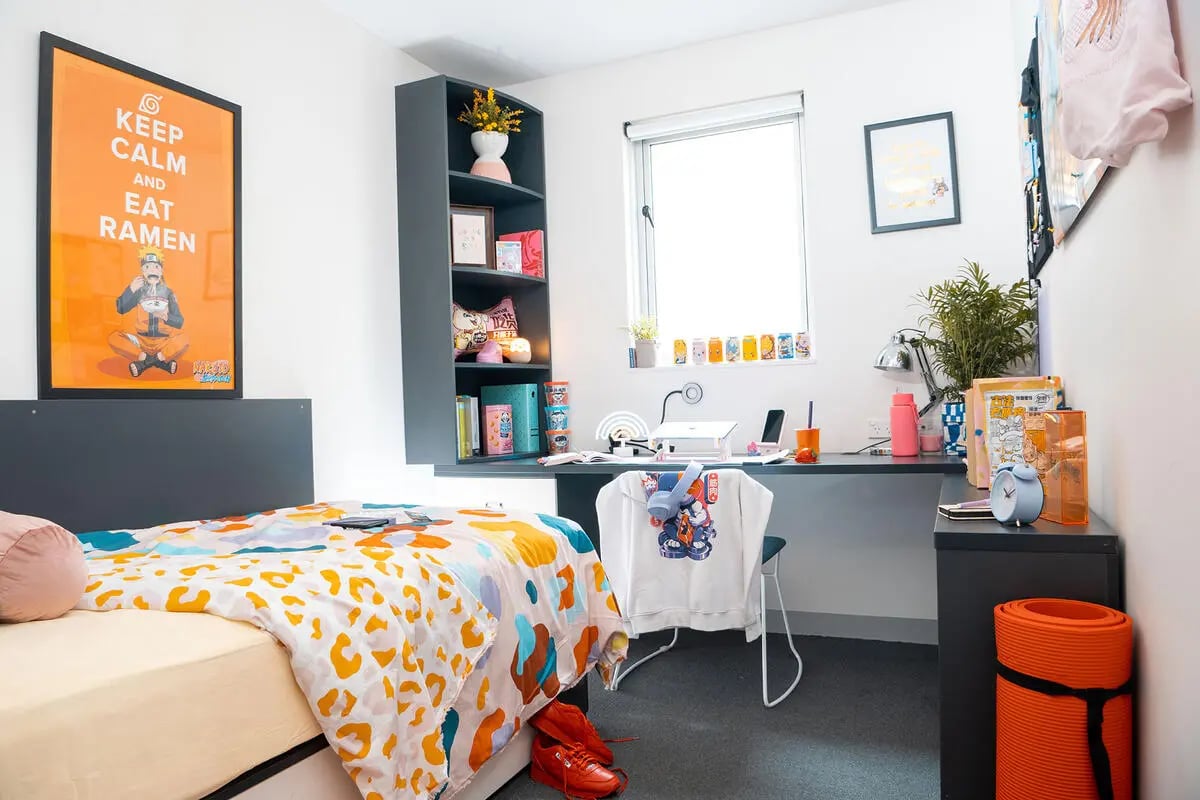 Bed desk shelves lamp plant study area bedroom at Scape Adelaide Central in Adelaide Student Accommodation