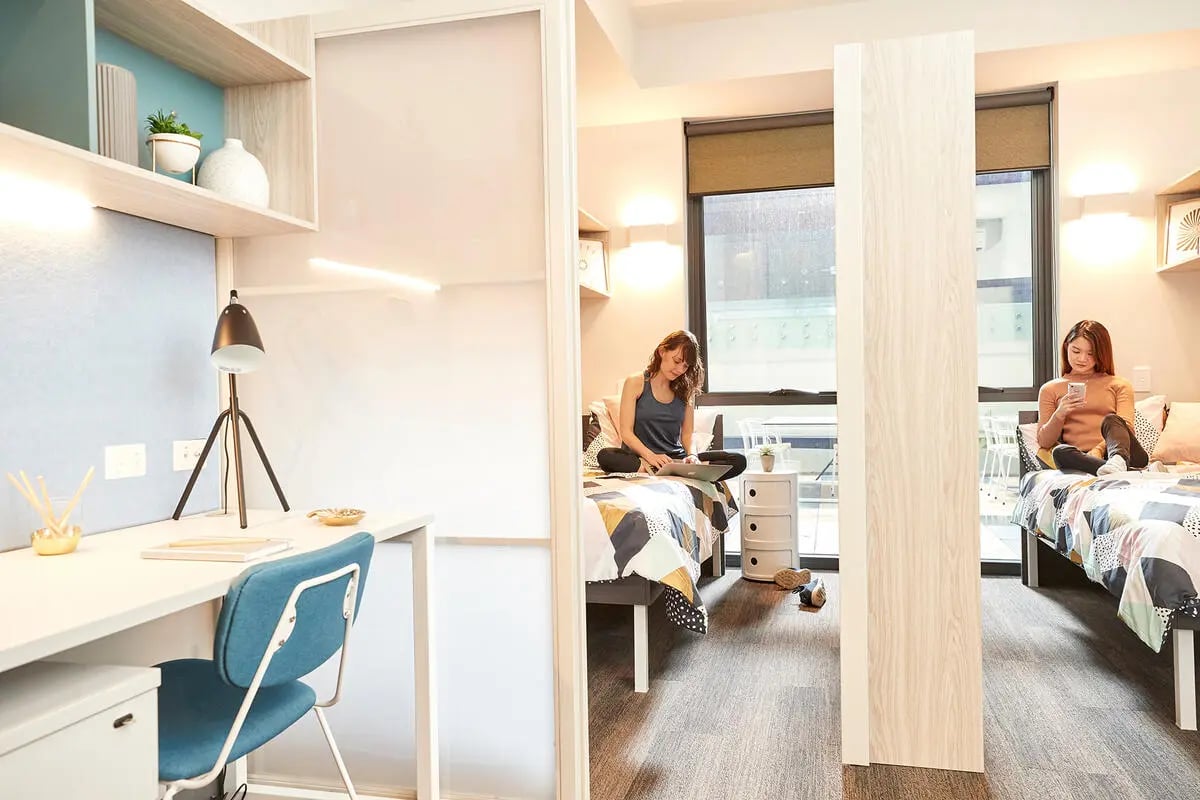 Desk lamp, chair, beds, two women bedroom study area at Scape Adelaide University in Adelaide Student Accommodation