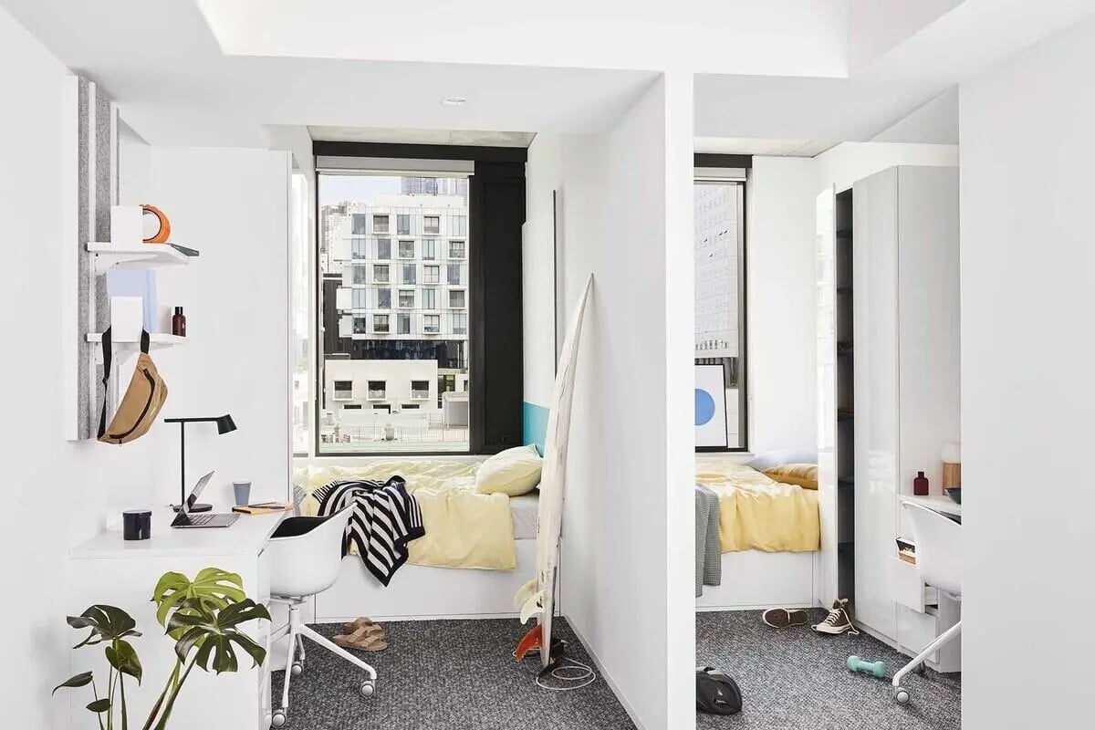 Desk bed plants shelves and wardrobe bedroom at Scape Lincoln College in Melbourne Student Accommodation