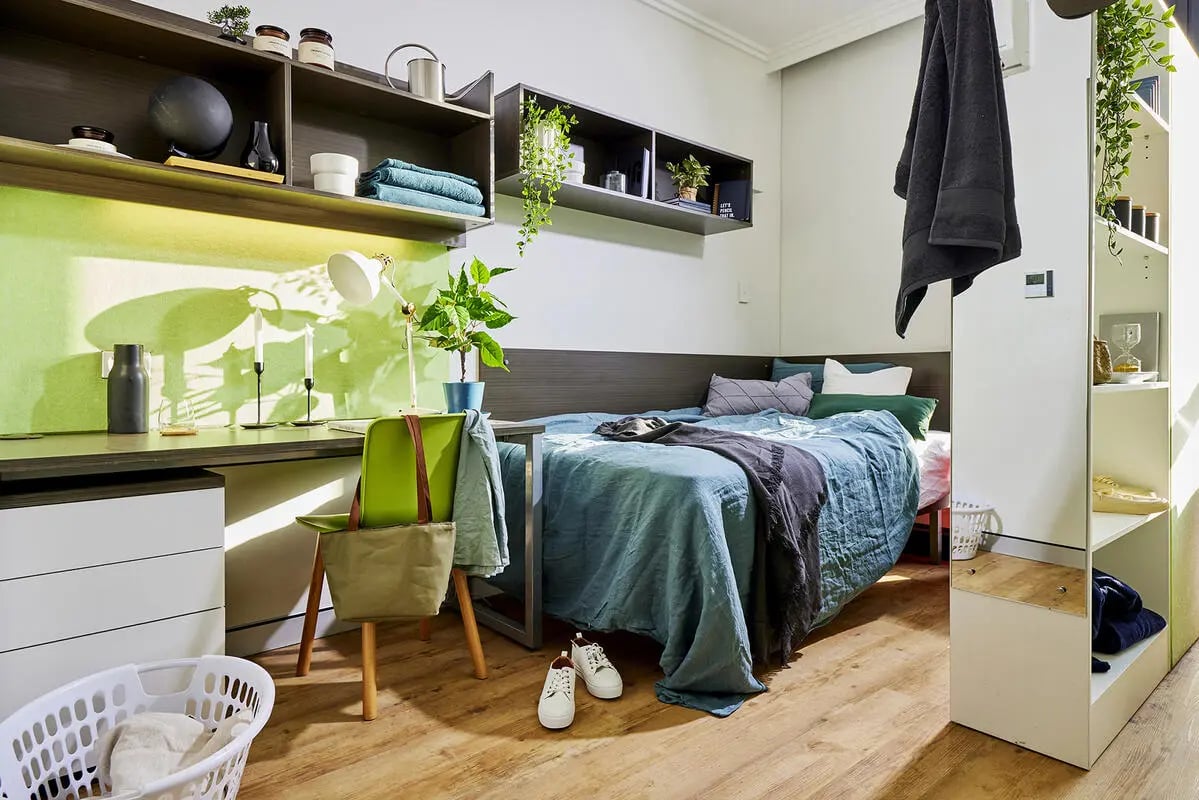 Desk bed chair and laundry basket bedroom at Scape at University of Sydney in Sydney Student Accommodation