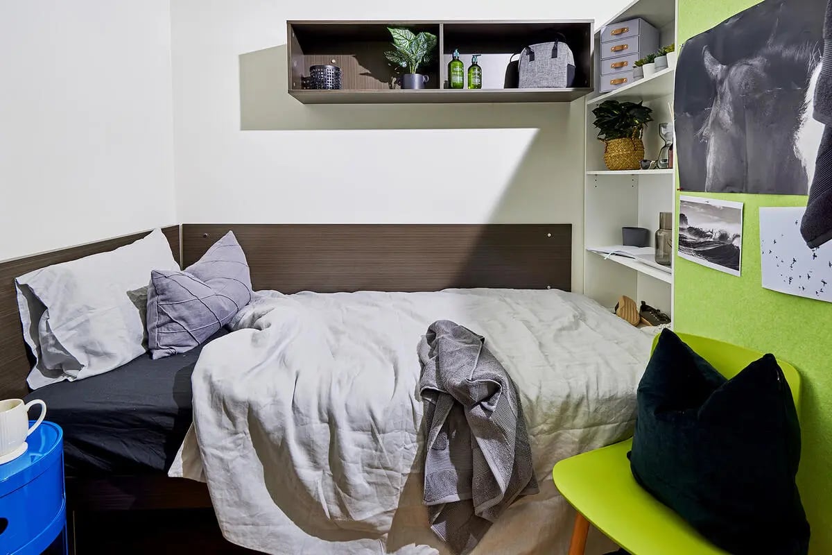 Bed with pillows and draped towel bedroom at Scape at University of Sydney in Sydney Student Accommodation