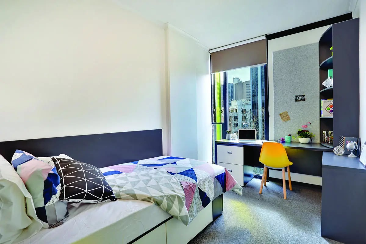 Bed desk chair and shelving unit bedroom at Scape Quay in Sydney Student Accommodation
