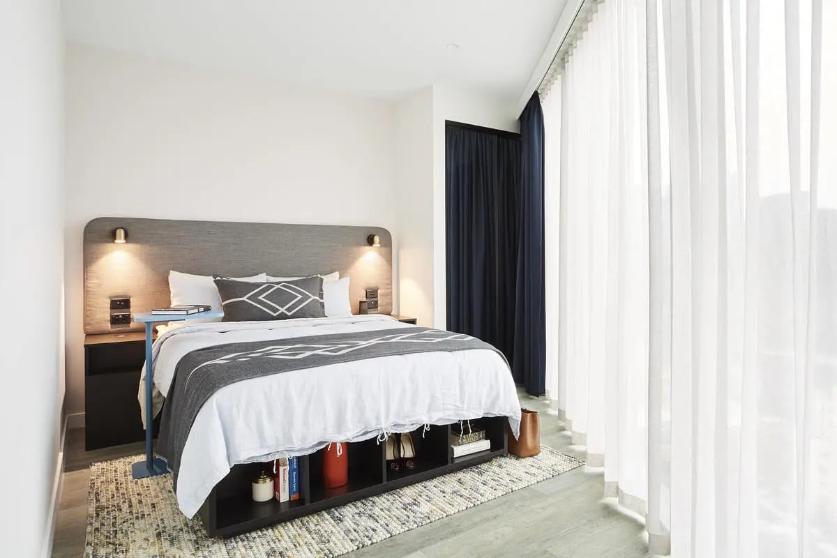 Bed with storage headboard and nightstand bedroom at Scape Aurora in Melbourne Student Accommodation