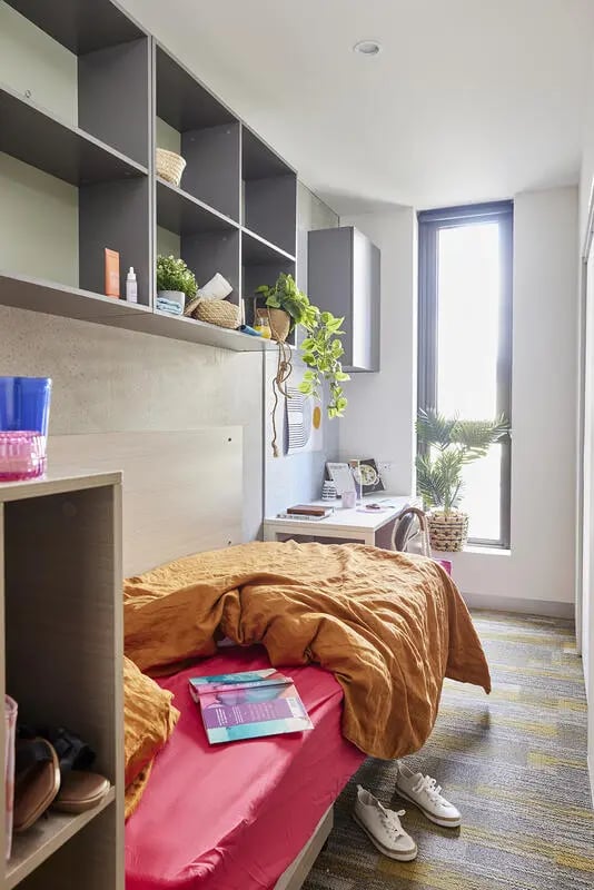 Bed study area shelving plants bedroom at Scape Berkeley 2 in Melbourne Student Accommodation
