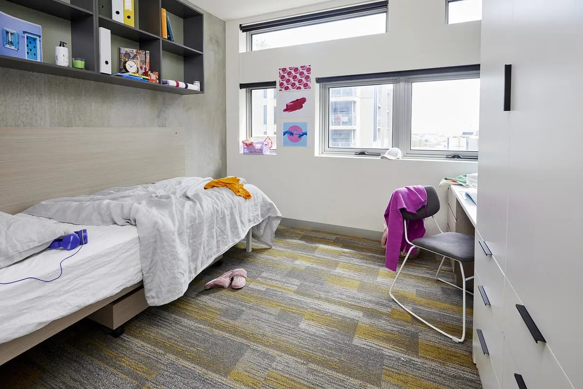 Bed desk chair shelving bedroom study area at Scape Berkeley 2 in Melbourne Student Accommodation
