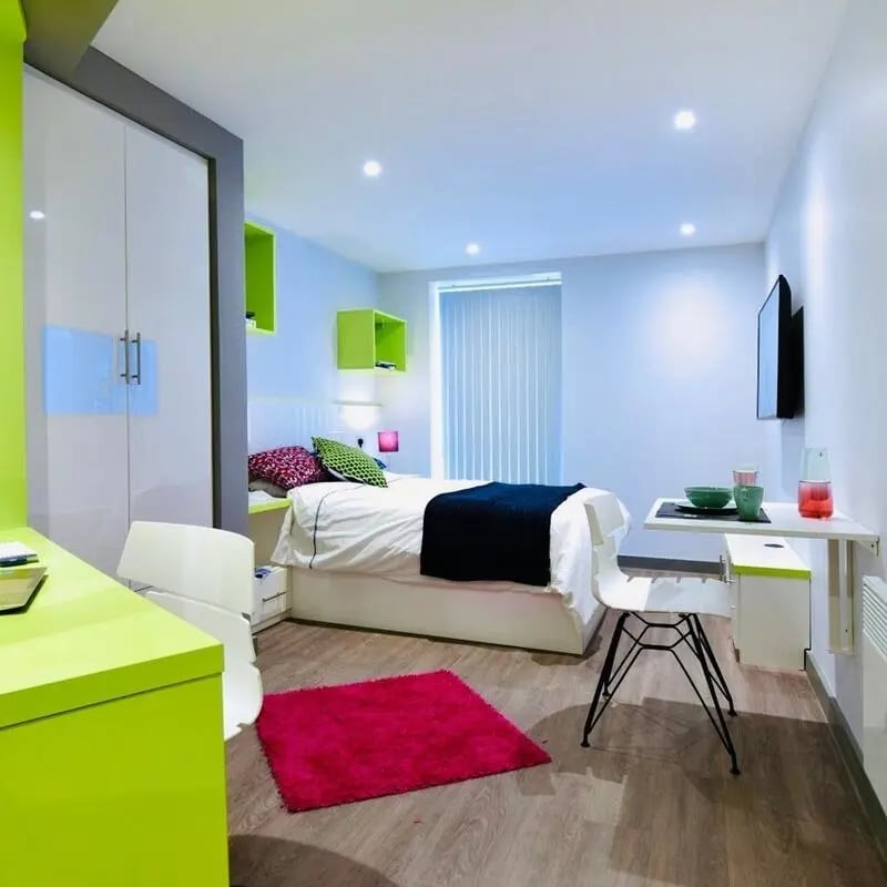 Bed, desk, TV, rug, closet bedroom at The Courtyard Block A in Huddersfield Student Accommodation