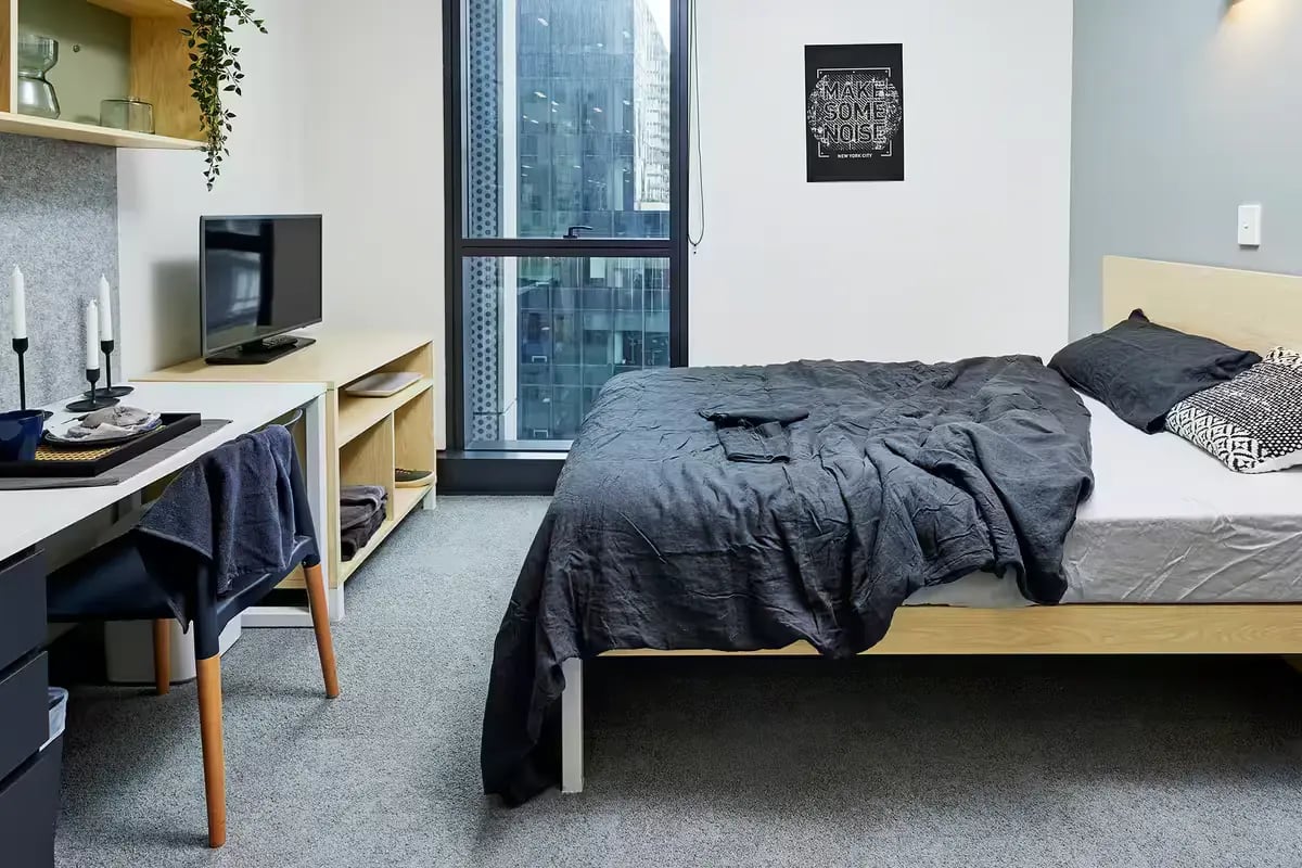Bed TV desk and shelves bedroom at Scape Darling Square in Sydney Student Accommodation