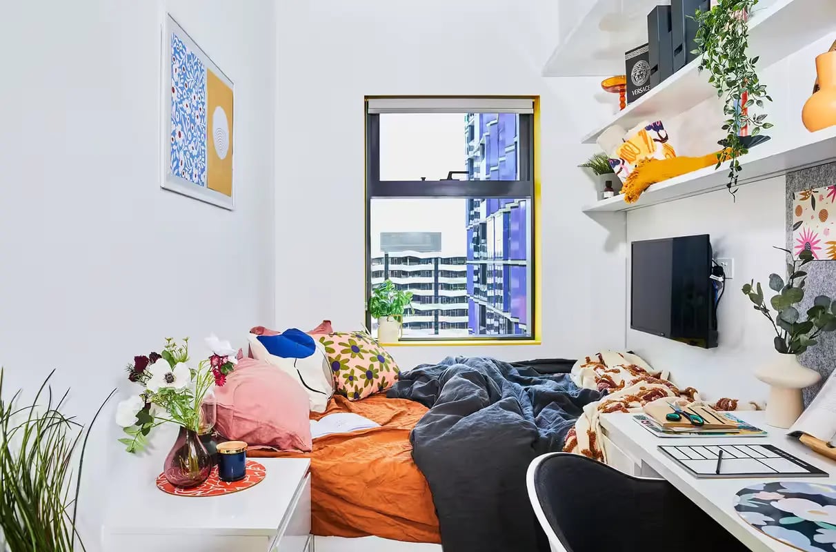 Bed pillows desk and television bedroom at Scape Franklin in Melbourne Student Accommodation