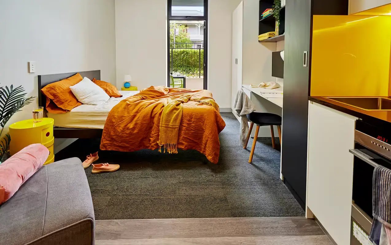 Bed study desk kitchen area living room at Scape Glebe in Sydney Student Accommodation