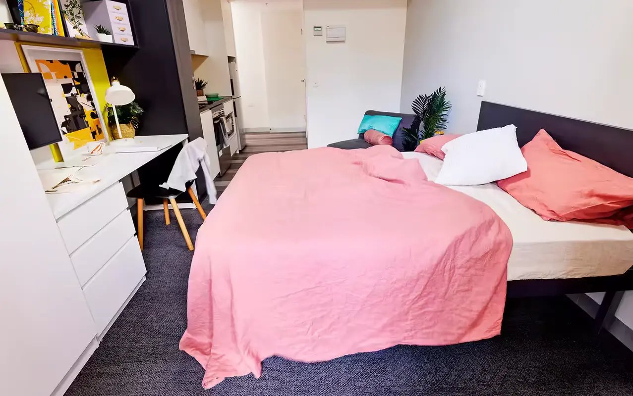 Bed desk kitchen furniture and sofa bedroom at Scape Glebe in Sydney Student Accommodation