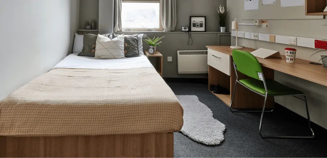 Bed desk chair and rug student bedroom at Northernhay House in Exeter Student Accommodation