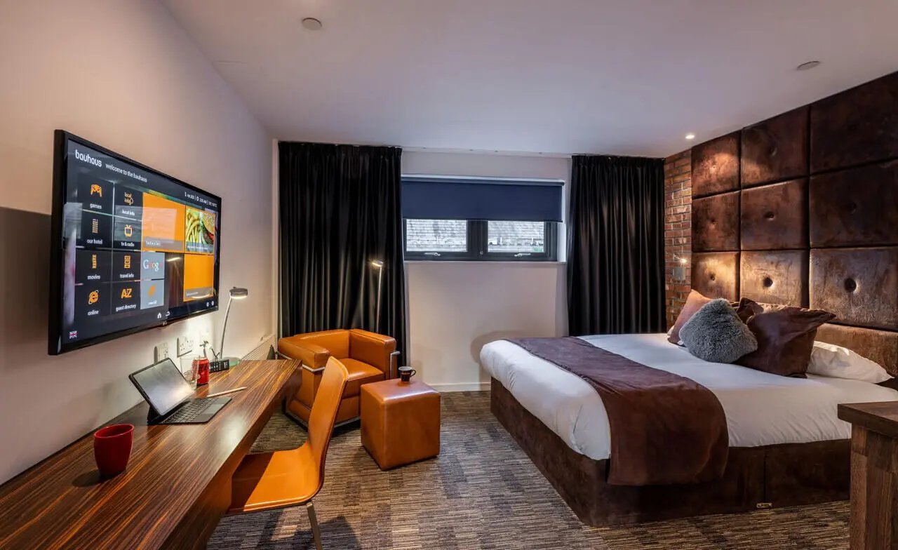Bed with TV desk chair and leather furniture bedroom at Bauhaus Student Langstane Place in Aberdeen Student Accommodation