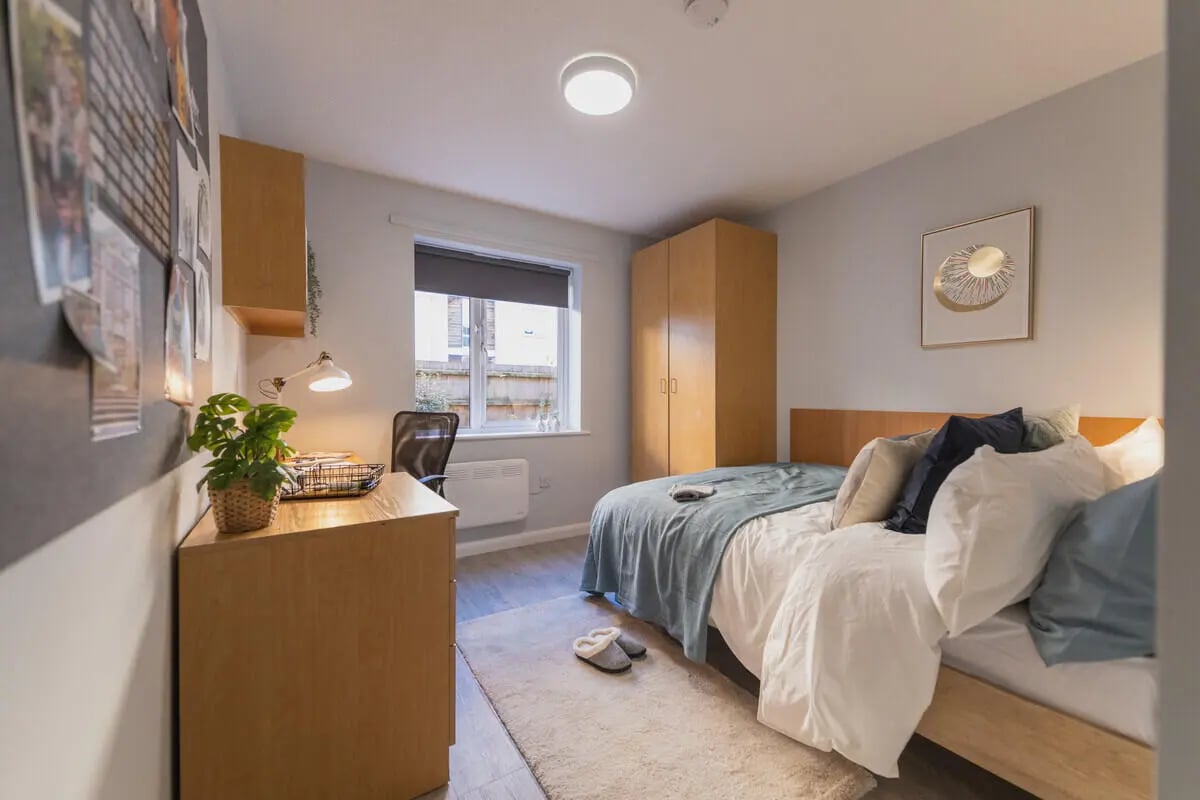 Bed desk wardrobe with bedding and pillows bedroom at Madison Gardens in Nottingham Student Accommodation