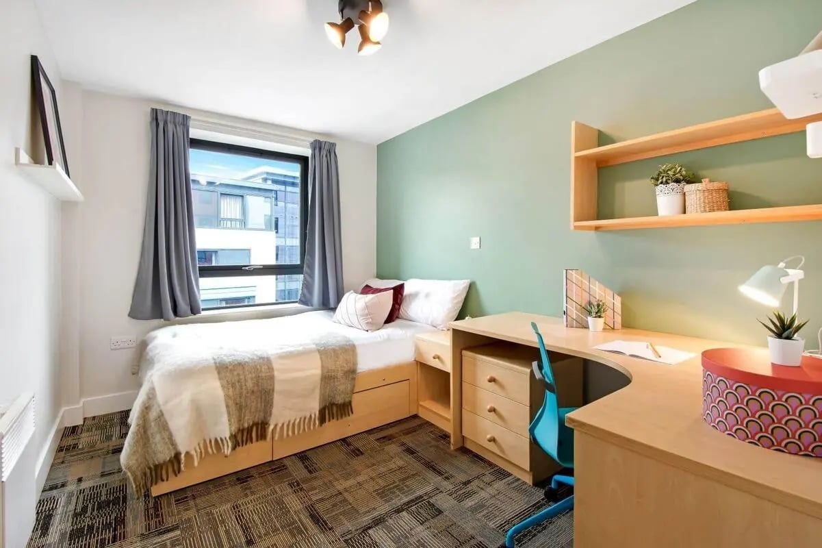 Bed desk chair with window and shelves Bedroom at The Triangle in Leeds Student Accommodation