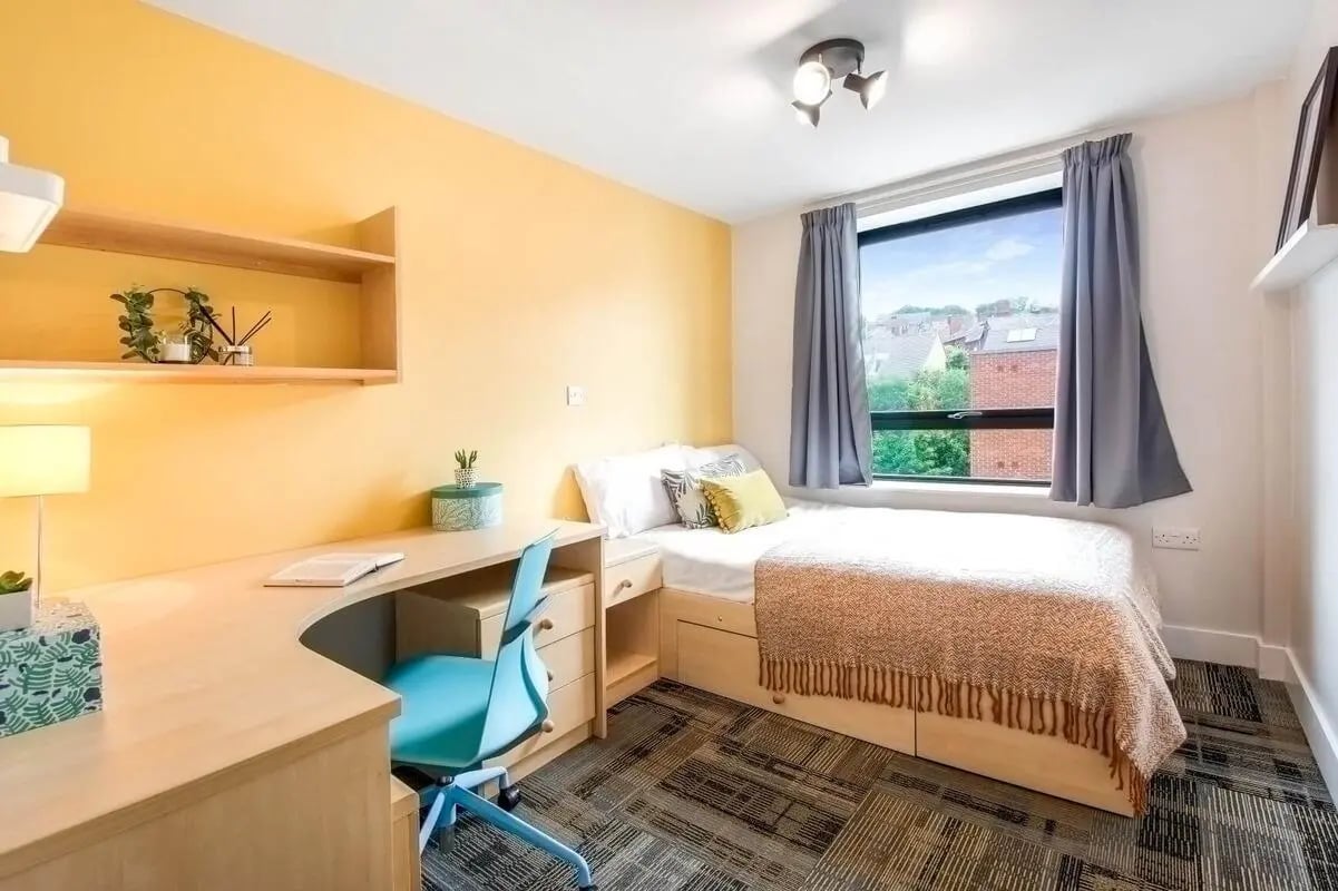 Desk bed chair and shelves bedroom at The Triangle in Leeds Student Accommodation