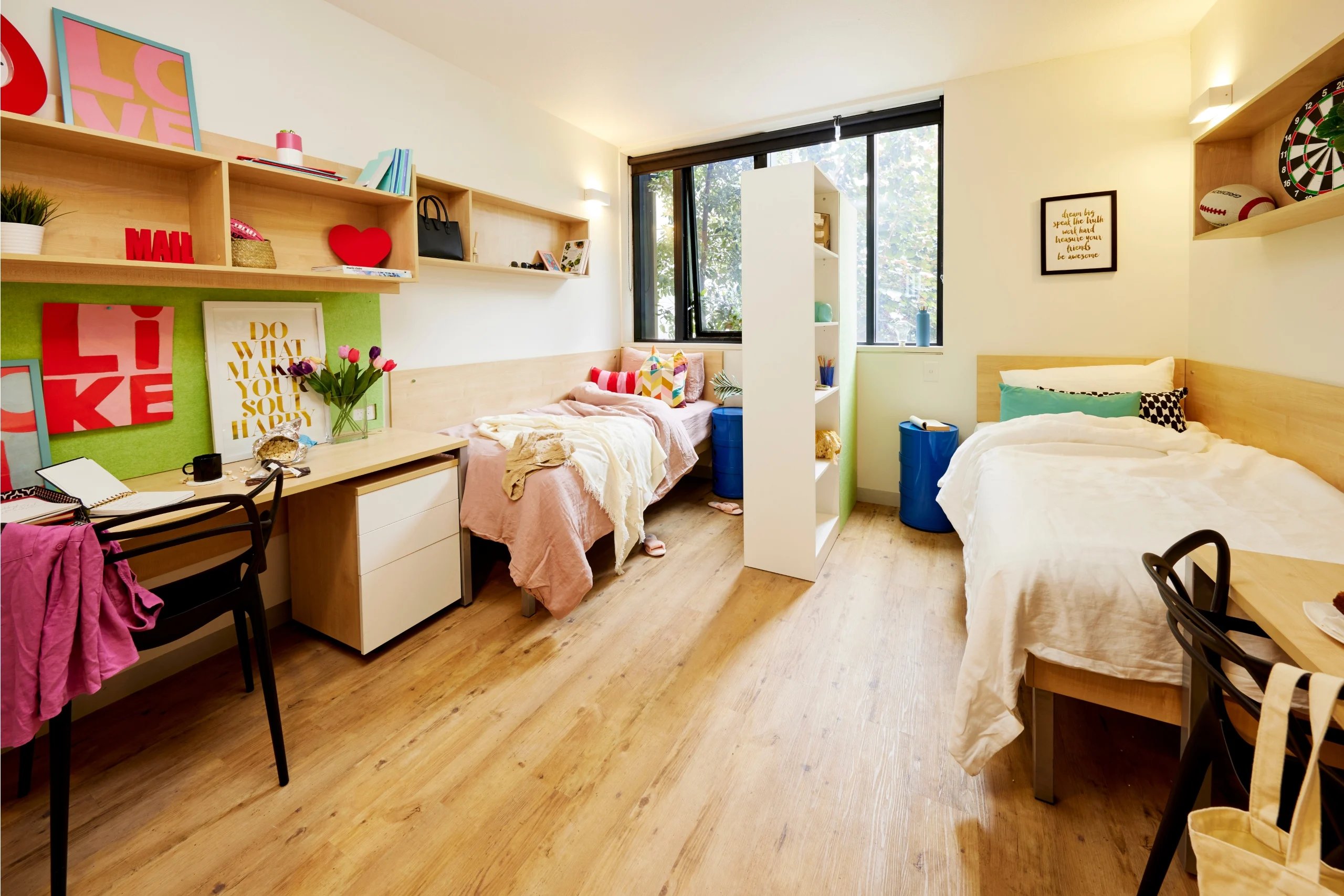 Two beds desk chair and pillows bedroom at Scape Sydney Central in Sydney Student Accommodation