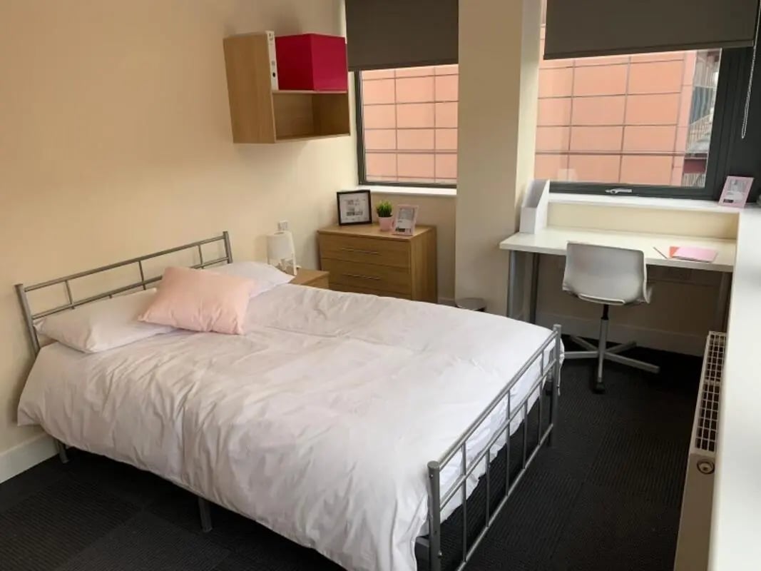 Bed bedside table dresser shelf desk chair bedroom at Newton House Glasgow in Glasgow Student Accommodation