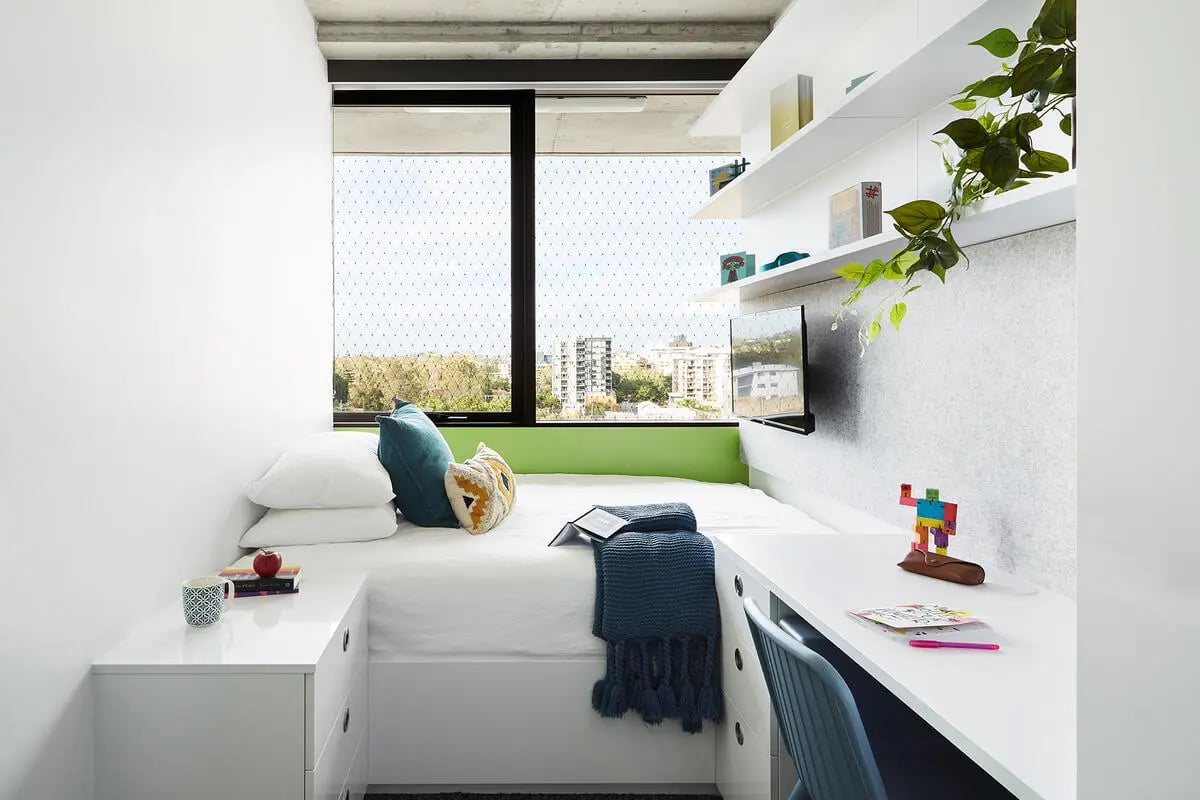 Bed desk pillows and television bedroom at Scape Toowong in Brisbane Student Accommodation