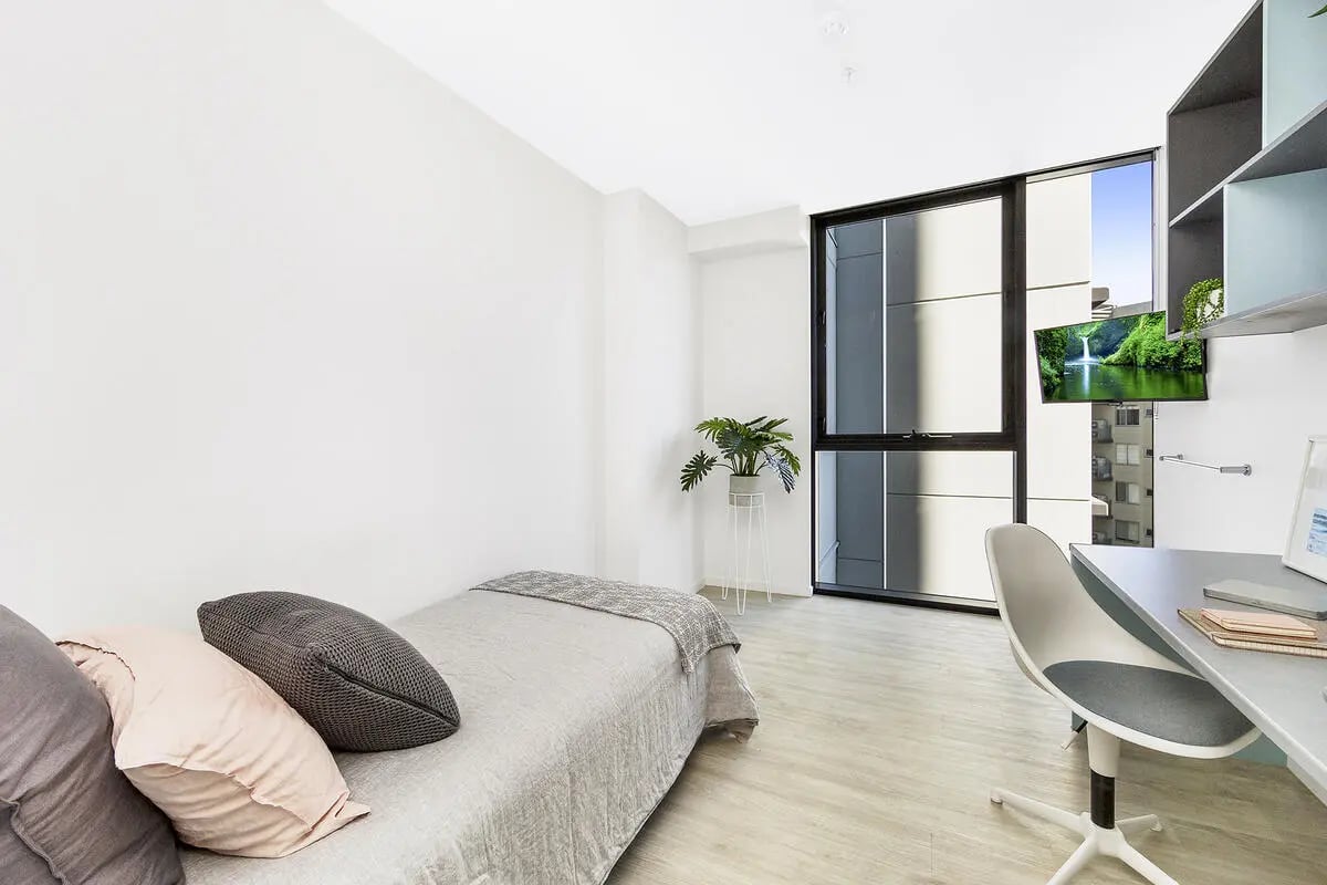 Bed desk plant and window bedroom at Scape Merivale in Brisbane Student Accommodation