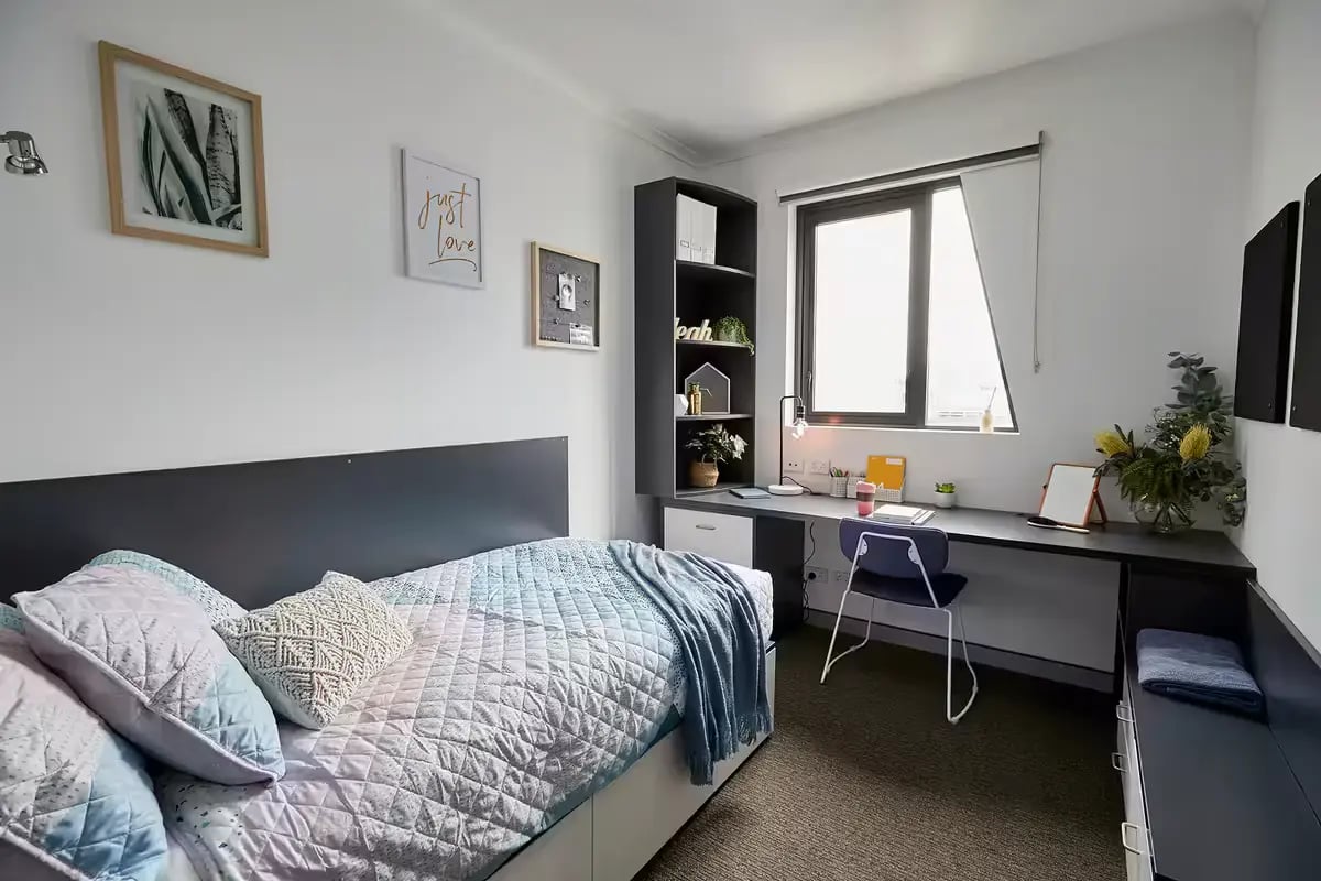 Bed desk and bookshelf student accommodation bedroom at Scape Tribune in Brisbane Student Accommodation