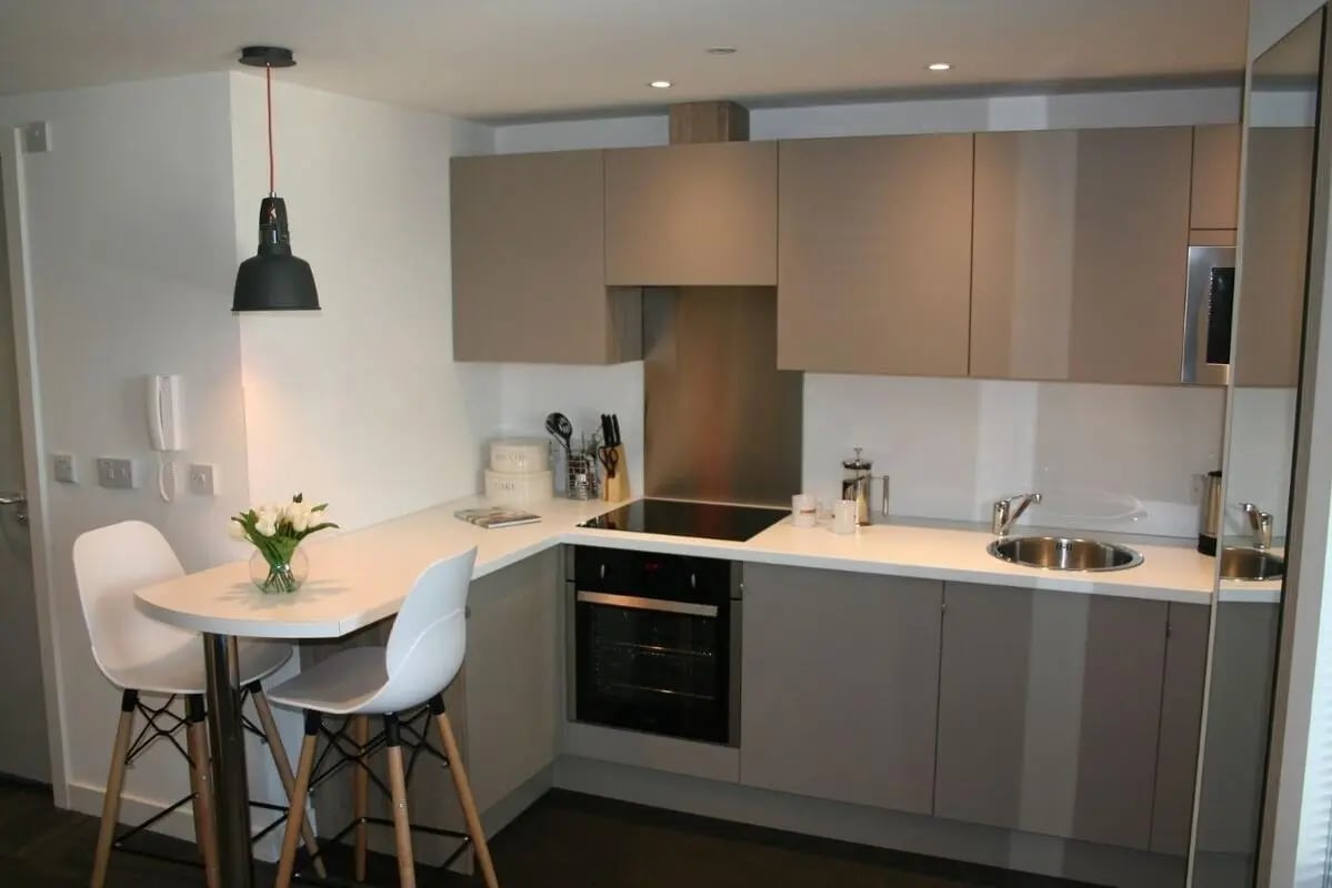 Compact kitchen with chairs sink and cabinets kitchen at CityBlock Penny Street in Lancaster Student Accommodation