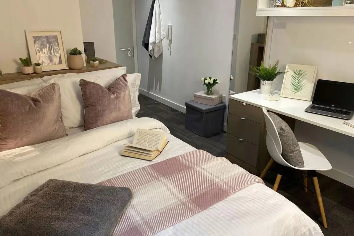 Bed desk plants and framed art bedroom at CityBlock Penny Street in Lancaster Student Accommodation