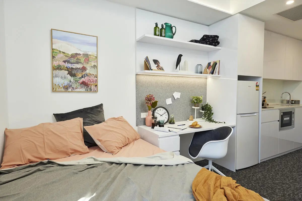 Bed desk fridge and shelves Bedroom and kitchen at Scape Redfern in Sydney Student Accommodation