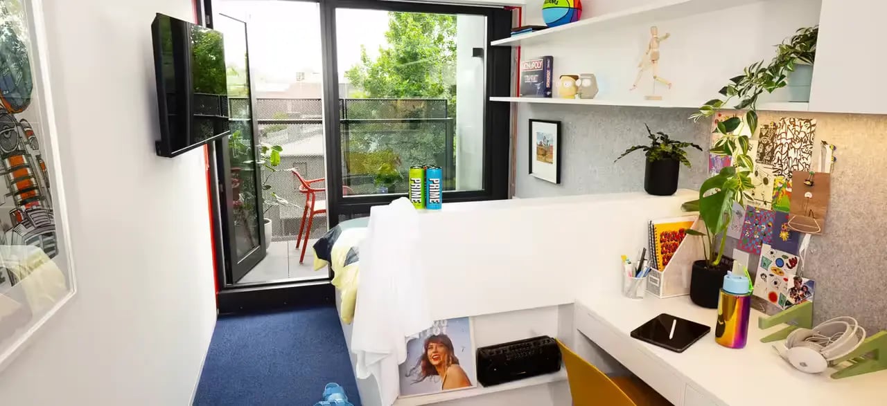 Bed TV balcony and desk study area at Scape Victoria Street in Melbourne Student Accommodation