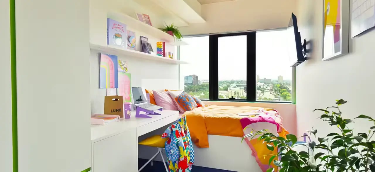 Desk bed and window view student bedroom at Scape Victoria Street in Melbourne Student Accommodation