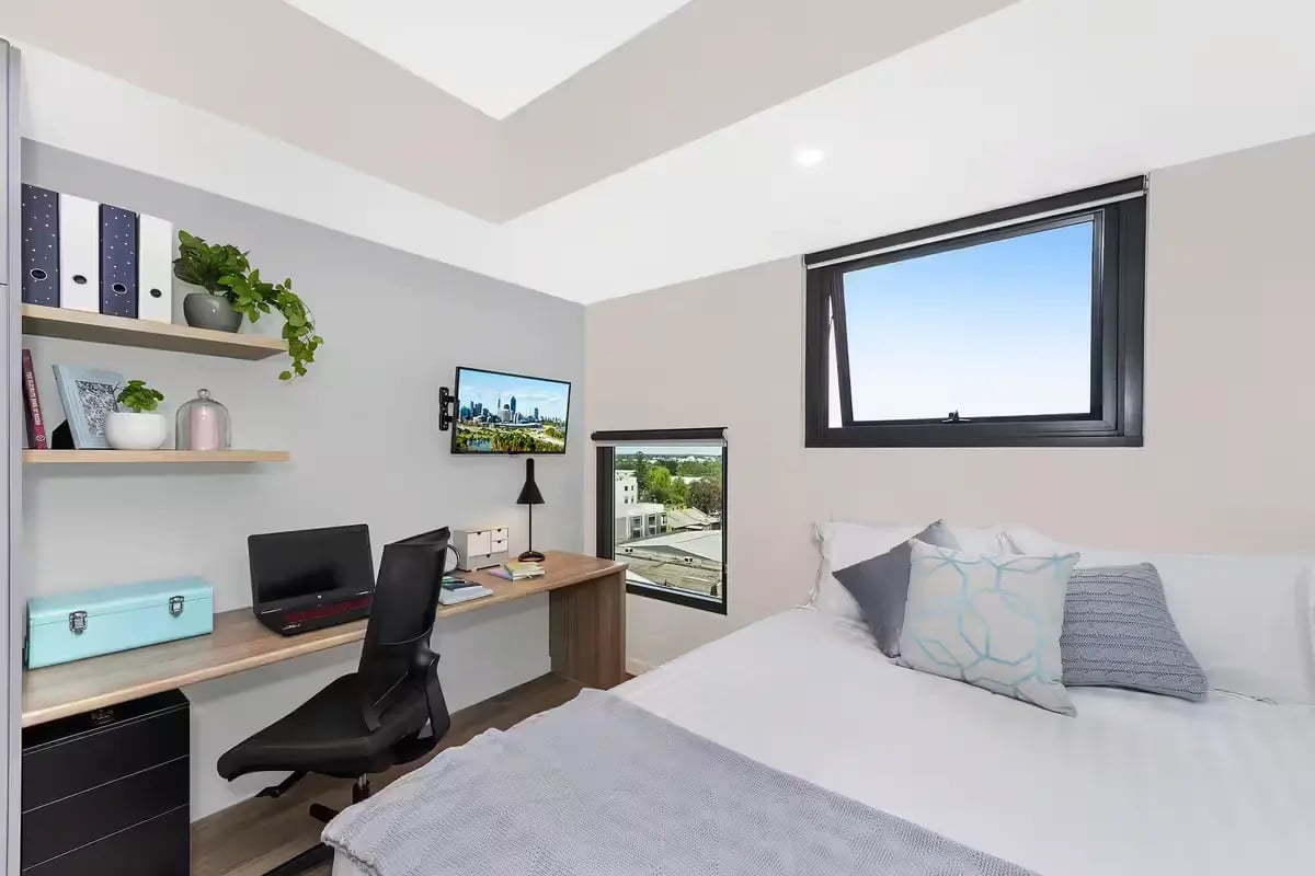 Desk laptop chair shelves and bed bedroom at Scape Waymouth in Adelaide Student Accommodation