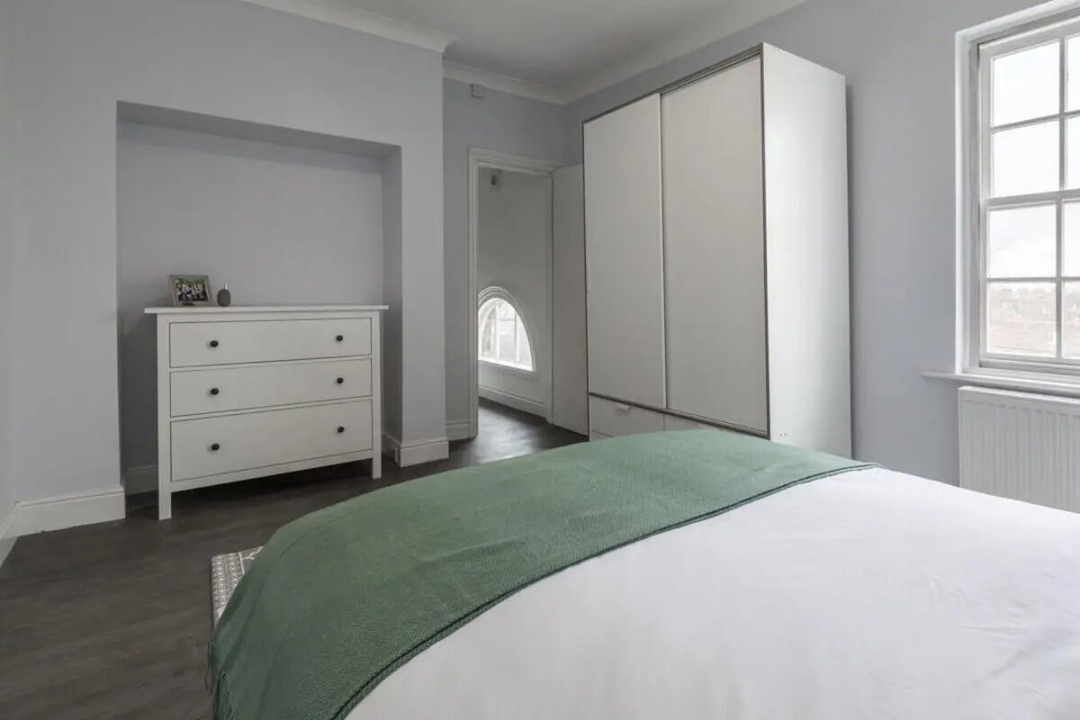 White dresser wardrobe and bed bedroom at Holgate Road in York Student Accommodation