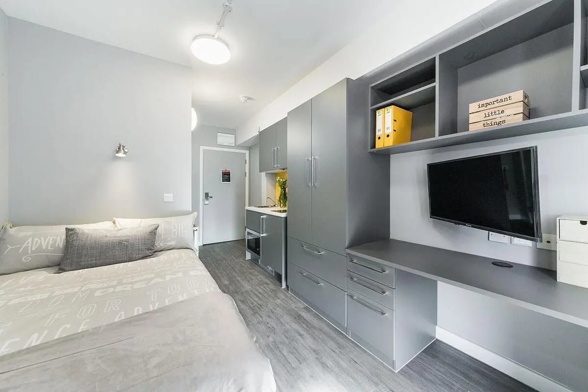 Bed desk kitchen cabinets TV and storage unit studio at Quayside Court in Newcastle Upon Tyne Student Accommodation