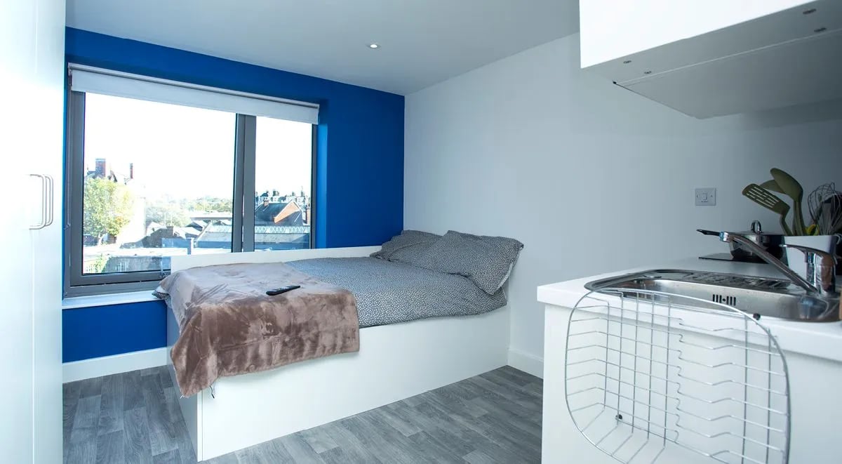 Bed sink and window view studio apartment at The Cube Greenwich in London Student Accommodation