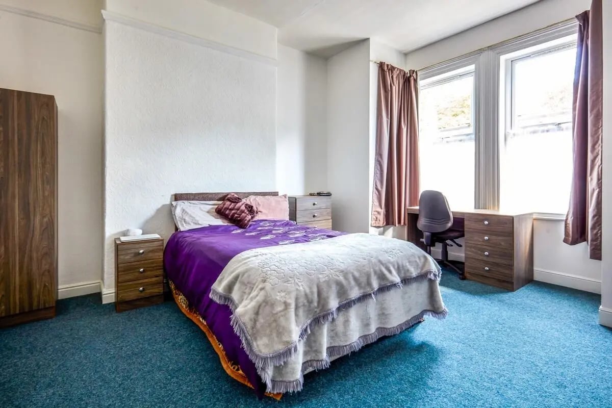 Bed desk wardrobe blue carpet bedroom at Humber Portfolio in Hull Student Accommodation