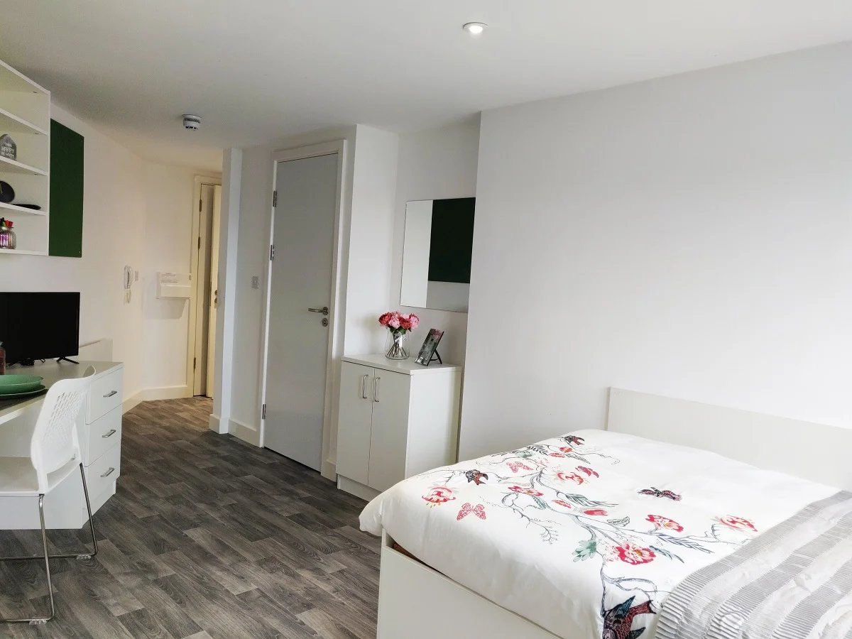 Bed desk and cabinets bedroom study area at The Cube Greenwich in London Student Accommodation