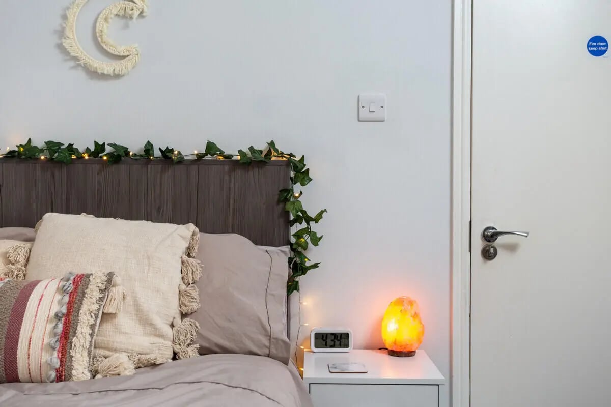 Bed with pillows fairy lights and lamp bedroom at Thornville Court Leeds in Leeds Student Accommodation