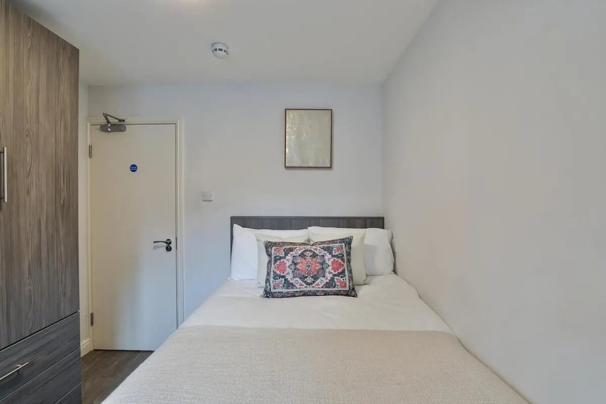 Closet door bed with decorative pillow bedroom at Thornville Court Leeds in Leeds Student Accommodation