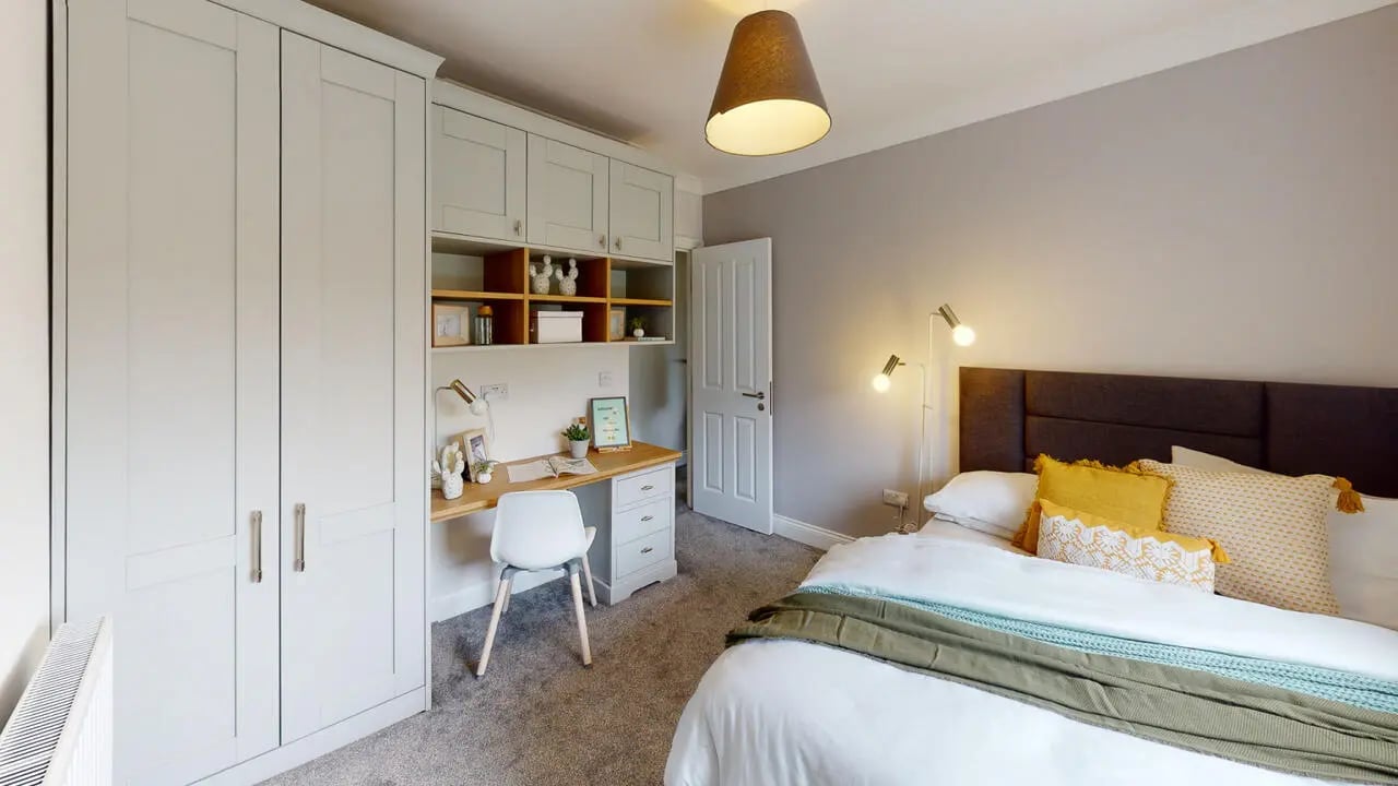 Wardrobe desk chair bed with yellow pillows bedroom at Picton Manor in Newcastle Upon Tyne Student Accommodation