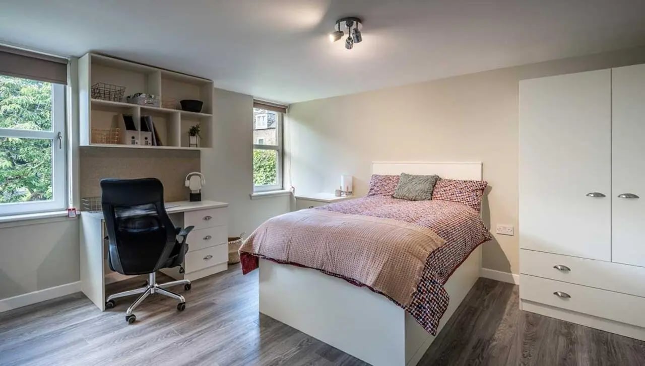Bed desk shelves wardrobe and window bedroom at Peterson Hall in Dundee Student Accommodation