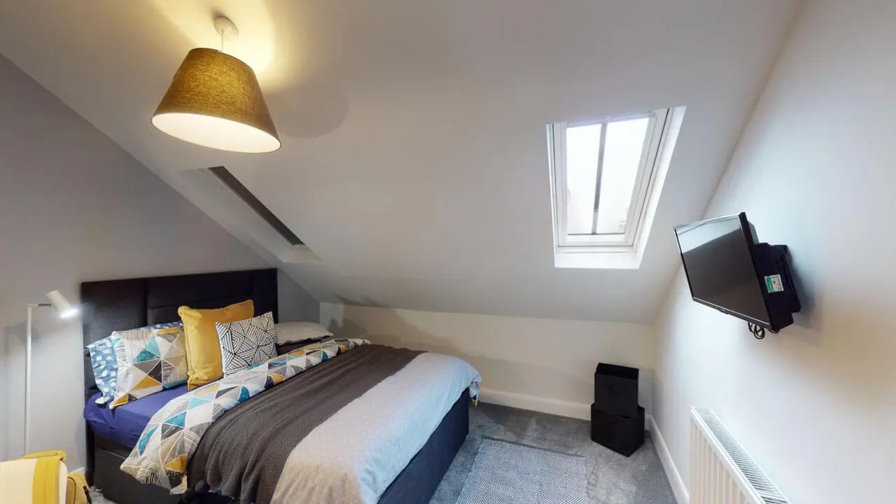 Bed with patterned bedding and wall mounted television bedroom at Picton Manor in Newcastle Upon Tyne Student Accommodation
