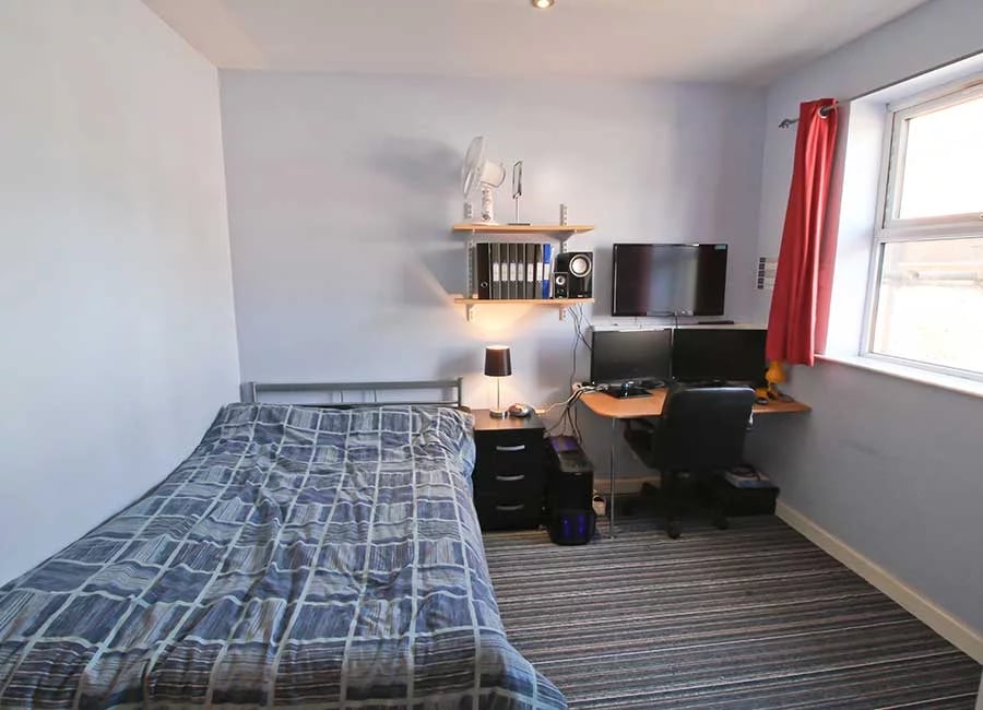 Bed desk computers fan and shelves bedroom at Radmoor House in Loughborough Student Accommodation