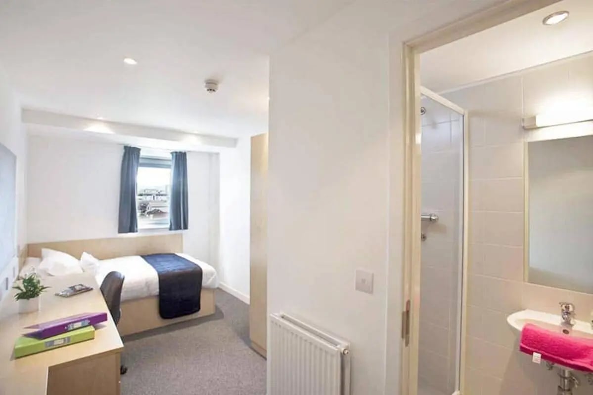 Bed desk and shower visible bedroom bathroom at Edinburgh College Residences in Edinburgh Student Accommodation