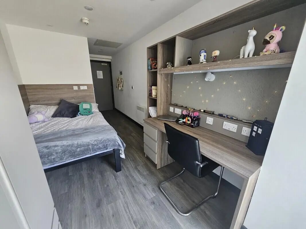 Bed desk chair and shelves Bedroom study area at Coppergate Swansea in Swansea Student Accommodation
